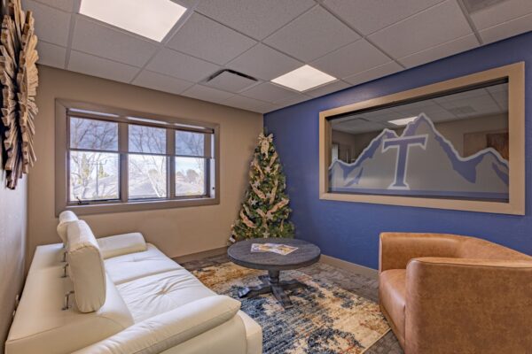 Commercial lobby with lighting, comfortable seating, and a window to the conference room.