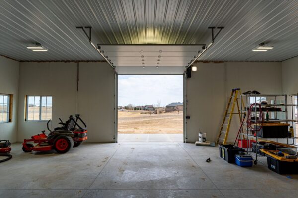 New build. Large garage featuring natural lighting and commercial garage doors.