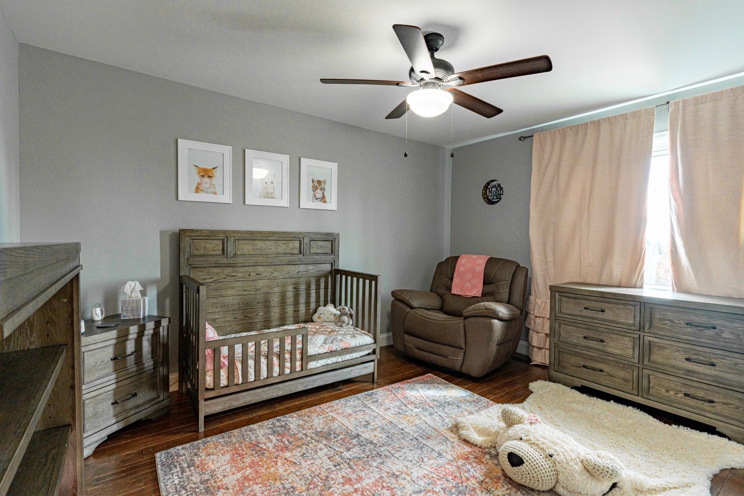 Updated child’s bedroom in a beautifully renovated home with hardwood flooring and elegant, functional lighting and fixtures.