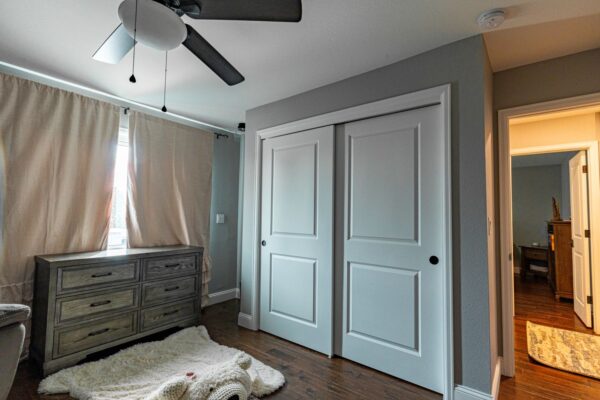 Updated child’s bedroom in a beautifully renovated home with hardwood flooring and ample storage and fixtures.