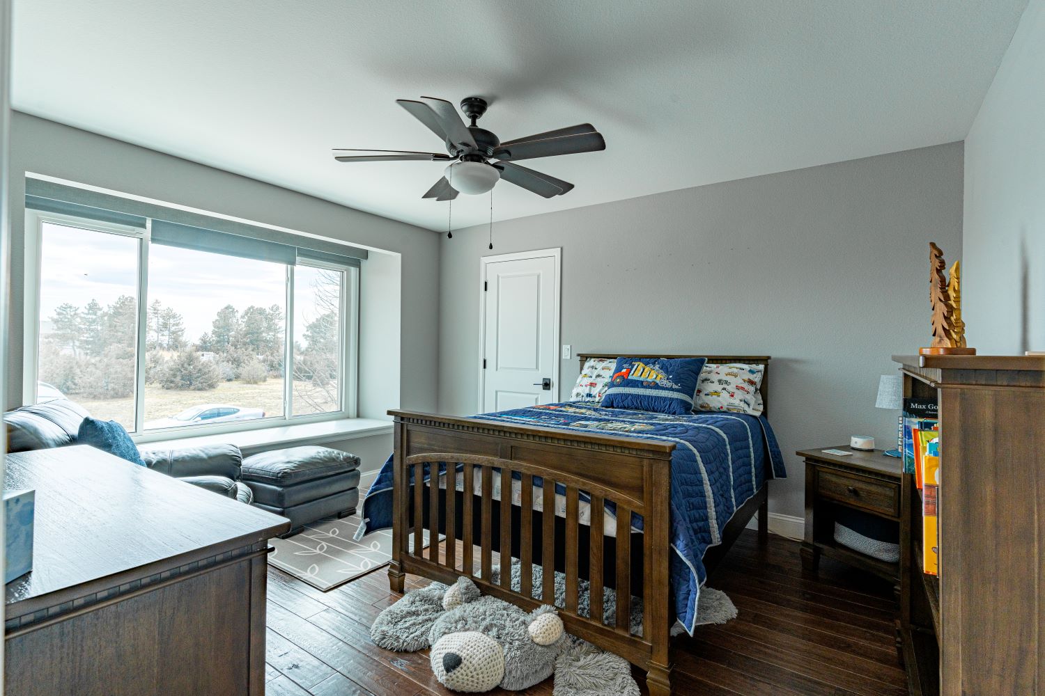 Updated child’s bedroom in a beautifully renovated home with hardwood flooring and elegant, functional lighting and fixtures.