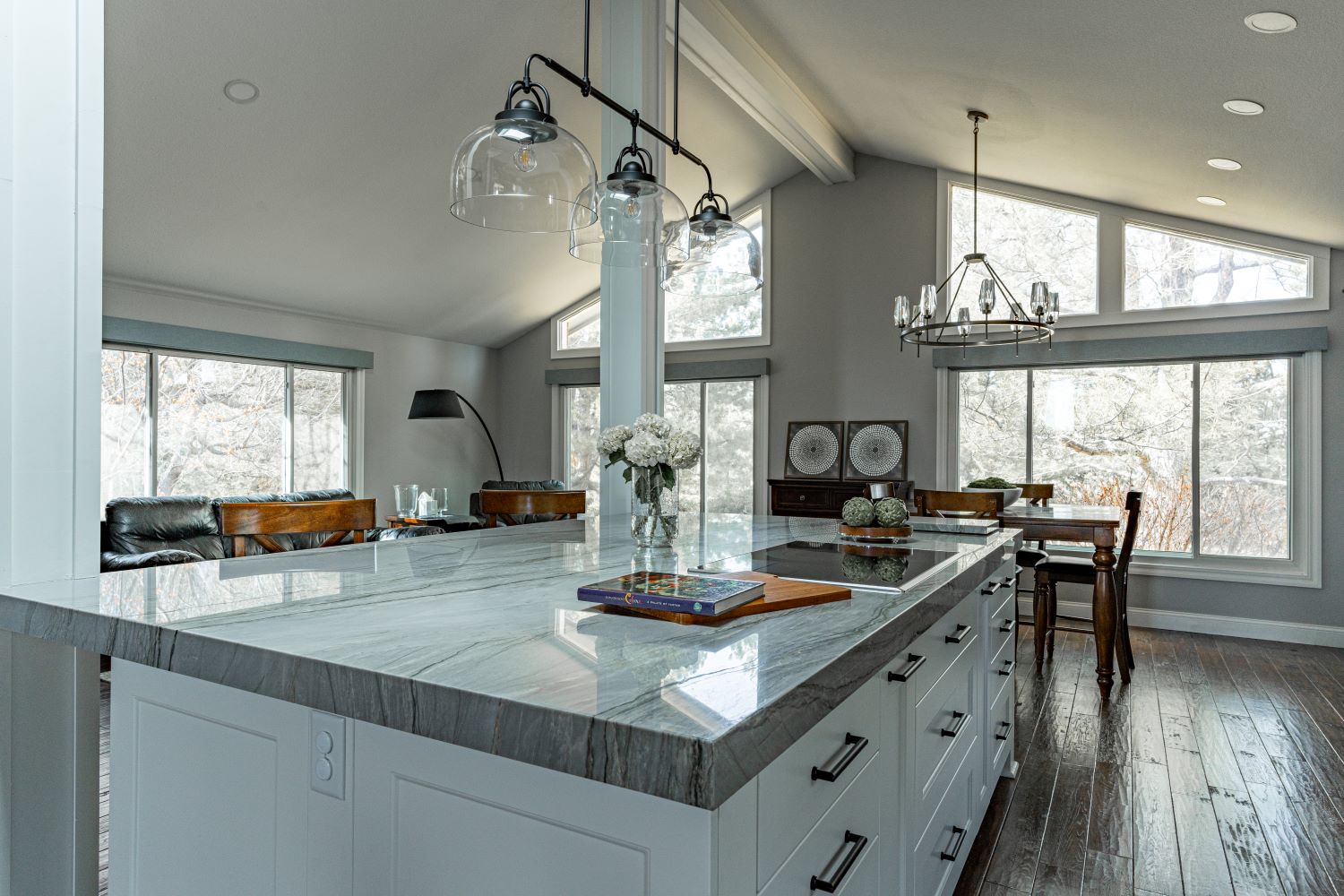 Renovated kitchen with island, ample storage and seating, elegant lighting, and an open, bright layout.